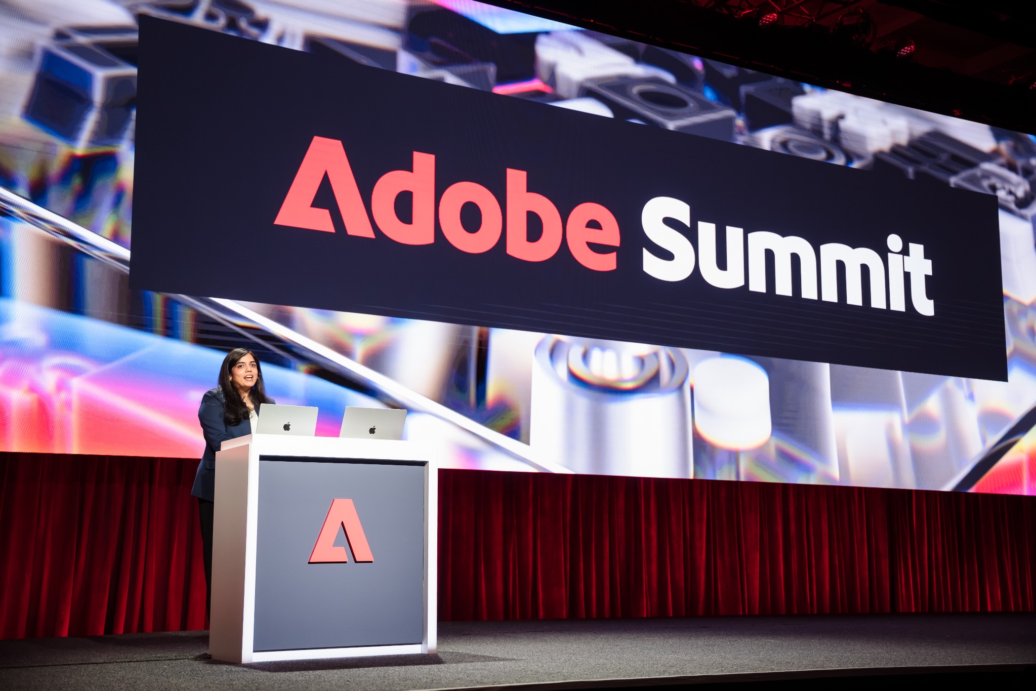 Namita presenting onstage at Adobe Summit